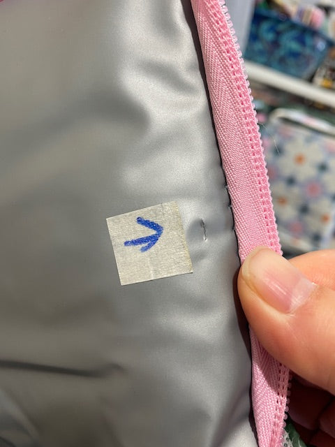 Close up of Lid lining showing the 2 tiny cuts approx 1mm each near the zipper on the right side.