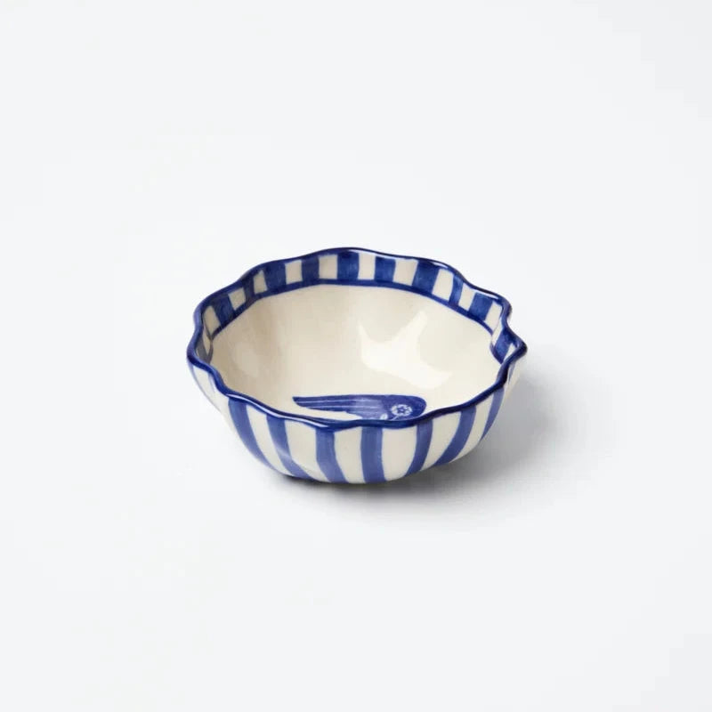 Small ceramic dish with blue and white striped pattern on a white background