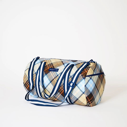 Side view of Plaid duffel bag with blue accents on a white background