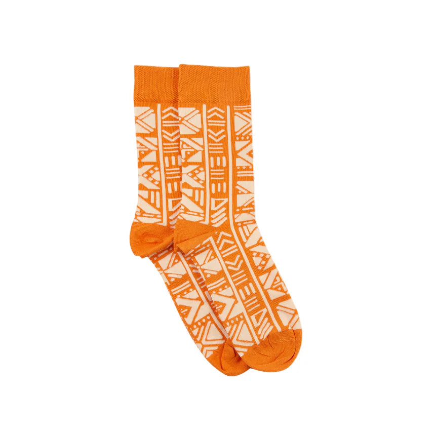 Orange socks with white geometric pattern on a white background