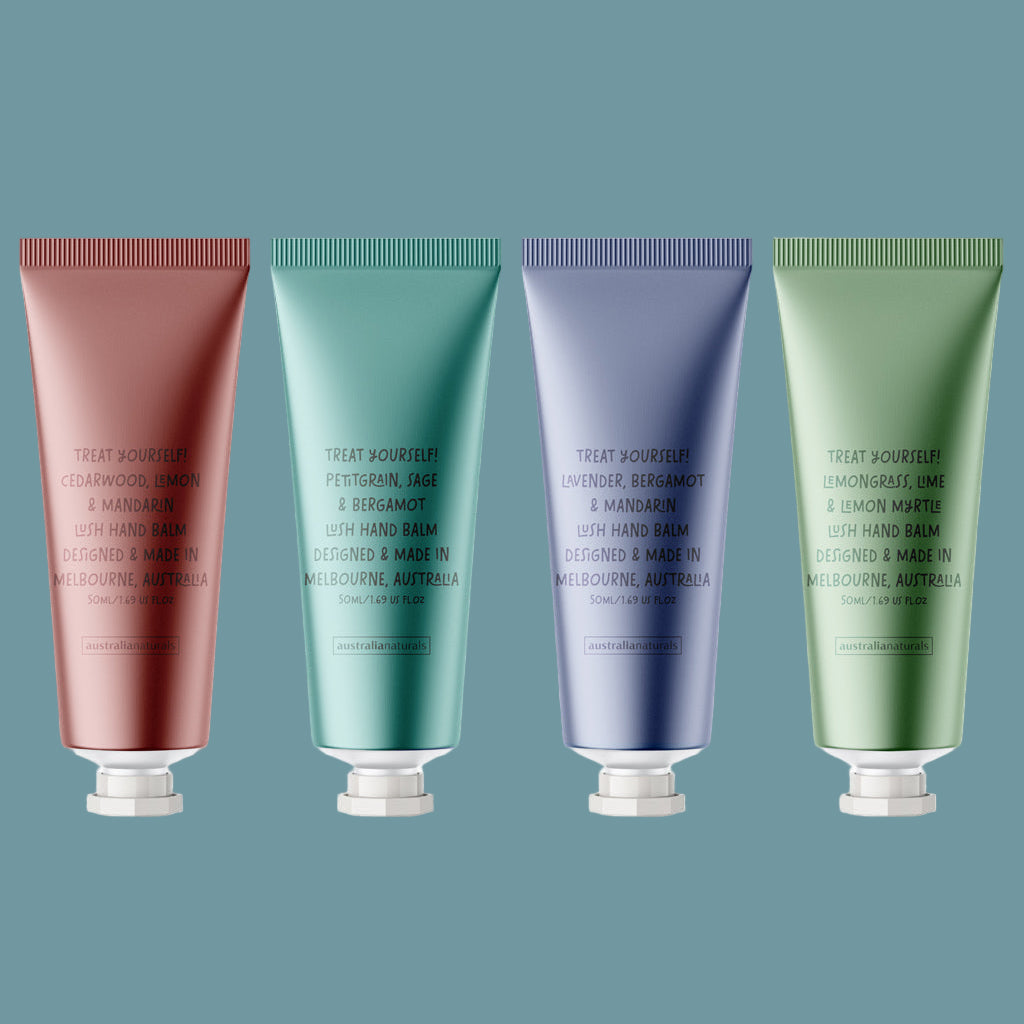Four hand balms in different colors on a blue background