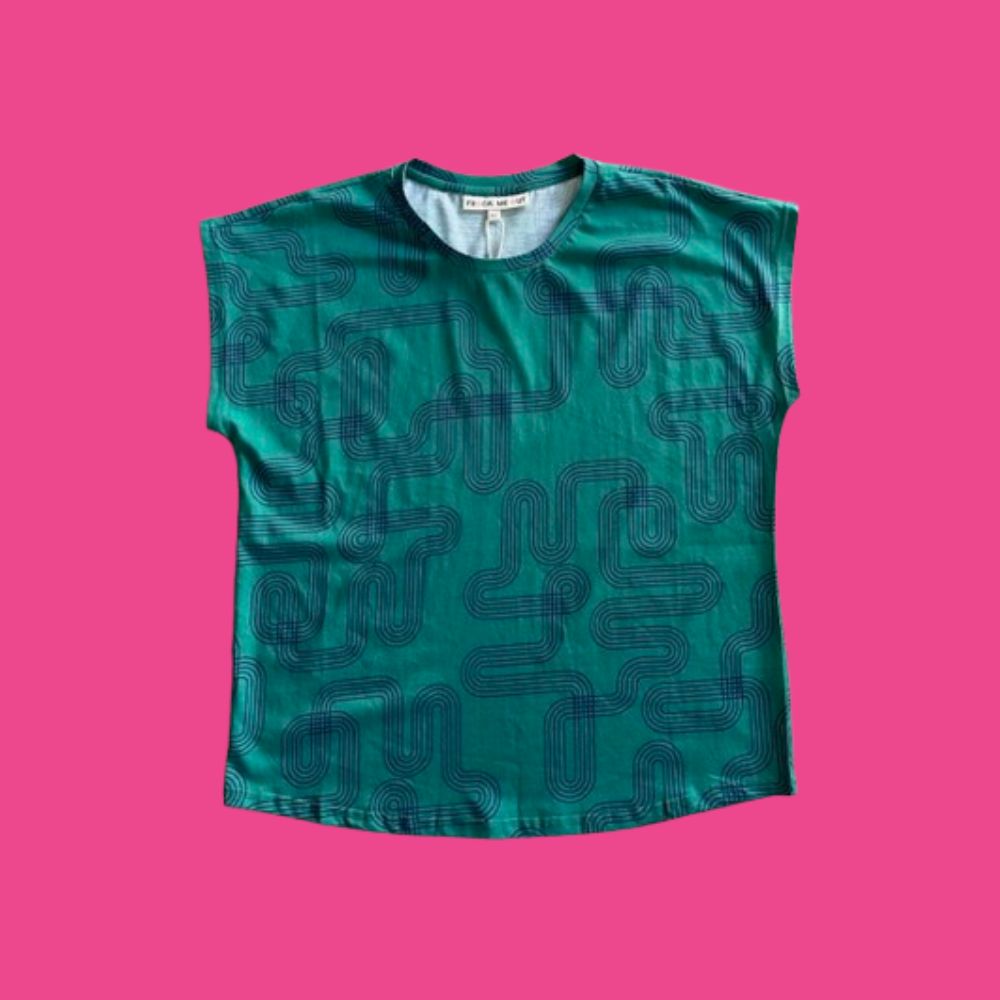Frock Me Out Labyrinth Capped Sleeve Tee - Green sleeveless shirt with navy blue geometric pattern on a pink background