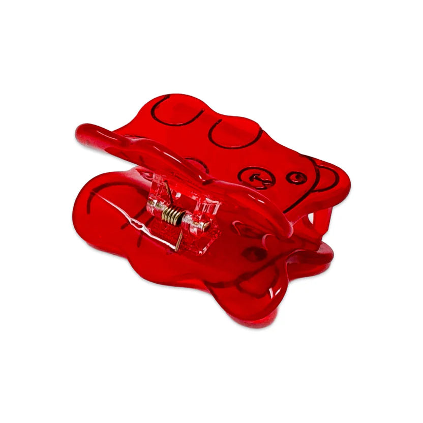 Side view of Red gummy bear hair clip with black outlines on a white background