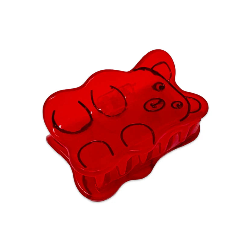 Side view of Red gummy bear hair clip with black outlines on a white background