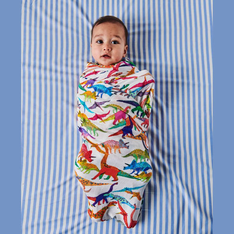 Kip & Co Dino Max Bamboo Baby Swaddle modelled by baby