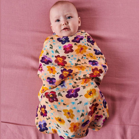 Kip & Co Pansy Bamboo Baby Swaddle modelled by baby