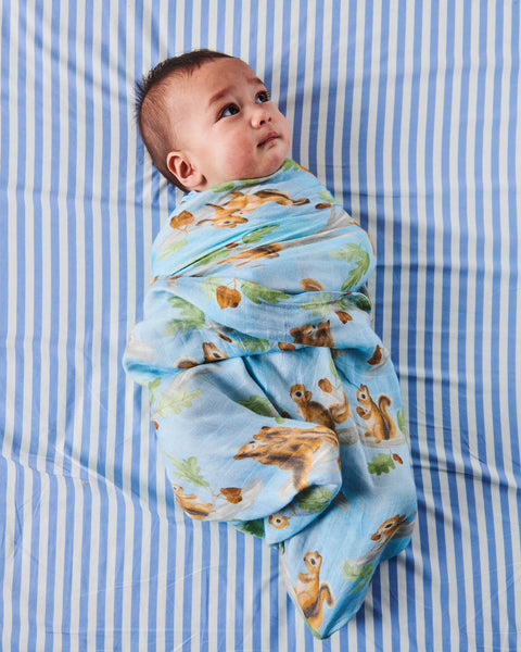 Kip & Co Squirrel Scurry Bamboo Baby Swaddle modelled by baby