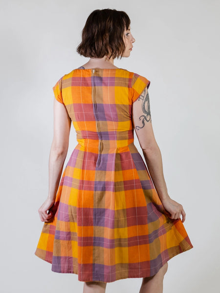 Back view of model wearing Mata Traders Devonshire Plaid Dress