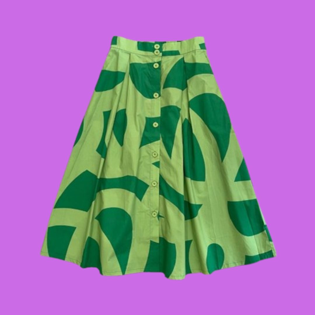 Green skirt with abstract squiggle pattern on a purple background