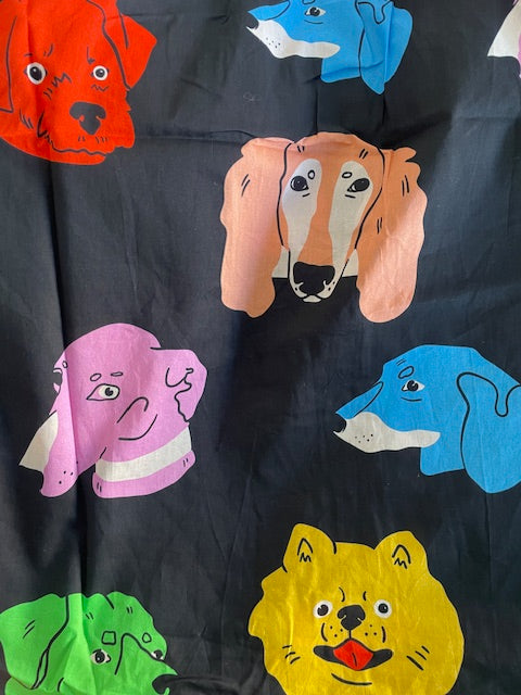 Black fabric with colourful dog illustrations