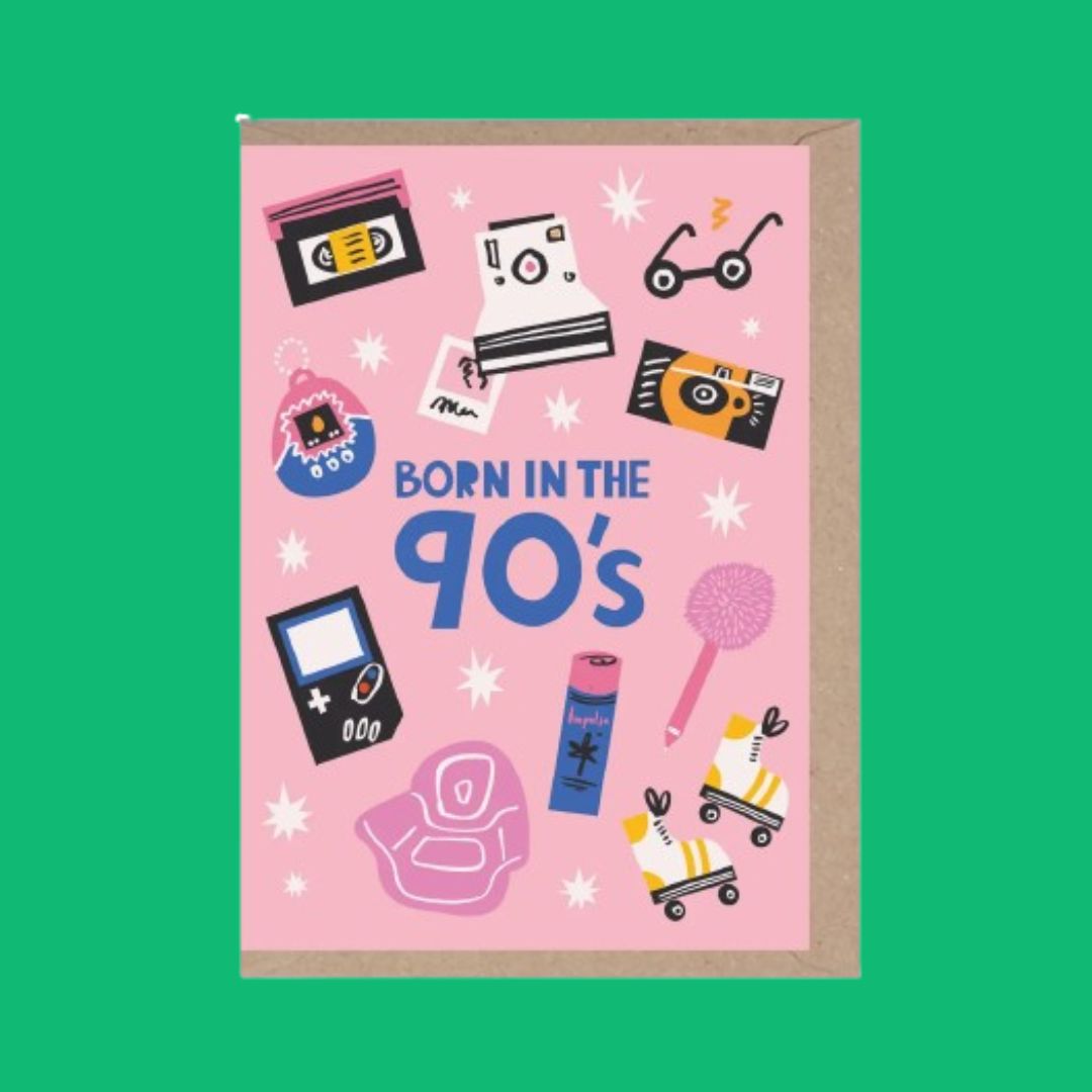 A pink greeting card with a brown kraft envelope, featuring retro 90s-themed illustrations and the text 'BORN IN THE 90's'. The card is displayed against a solid green background.