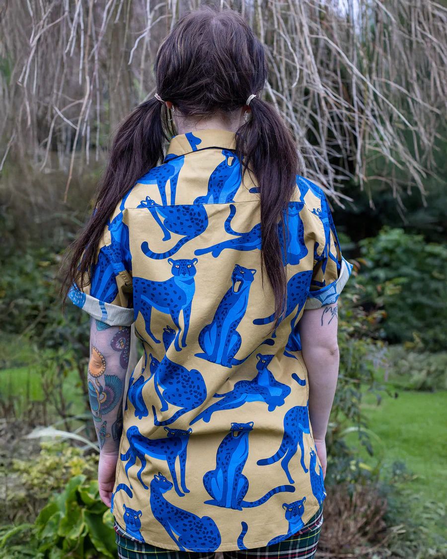 Back view of model wearing a Run and Fly Leopard Shirt