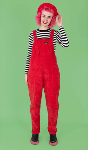 Model is wearing Run & Fly Red Cord Dungarees with a black and white striped long sleeve top underneath. 