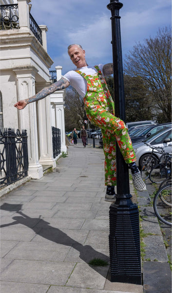 Model is up on a lamppost wearing Run and Fly x The Mushroom Babes In The Geese Garden Stretch Twill Dungarees.