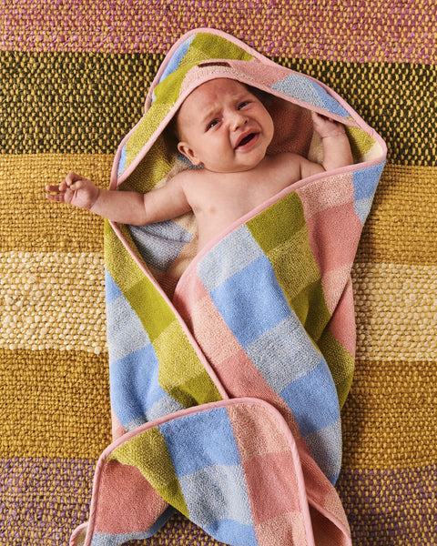 Kip & Co Corfu Tartan Terry Baby Towel wrapped around a small baby