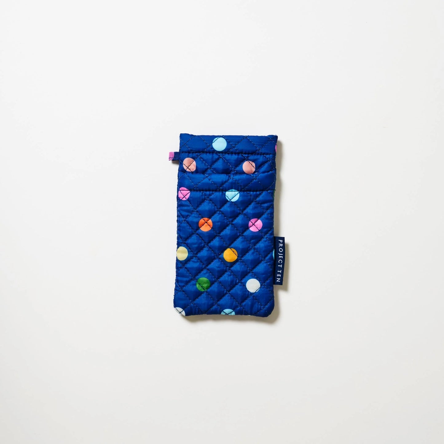 Blue quilted glasses pouch with colorful polka dots on a white background