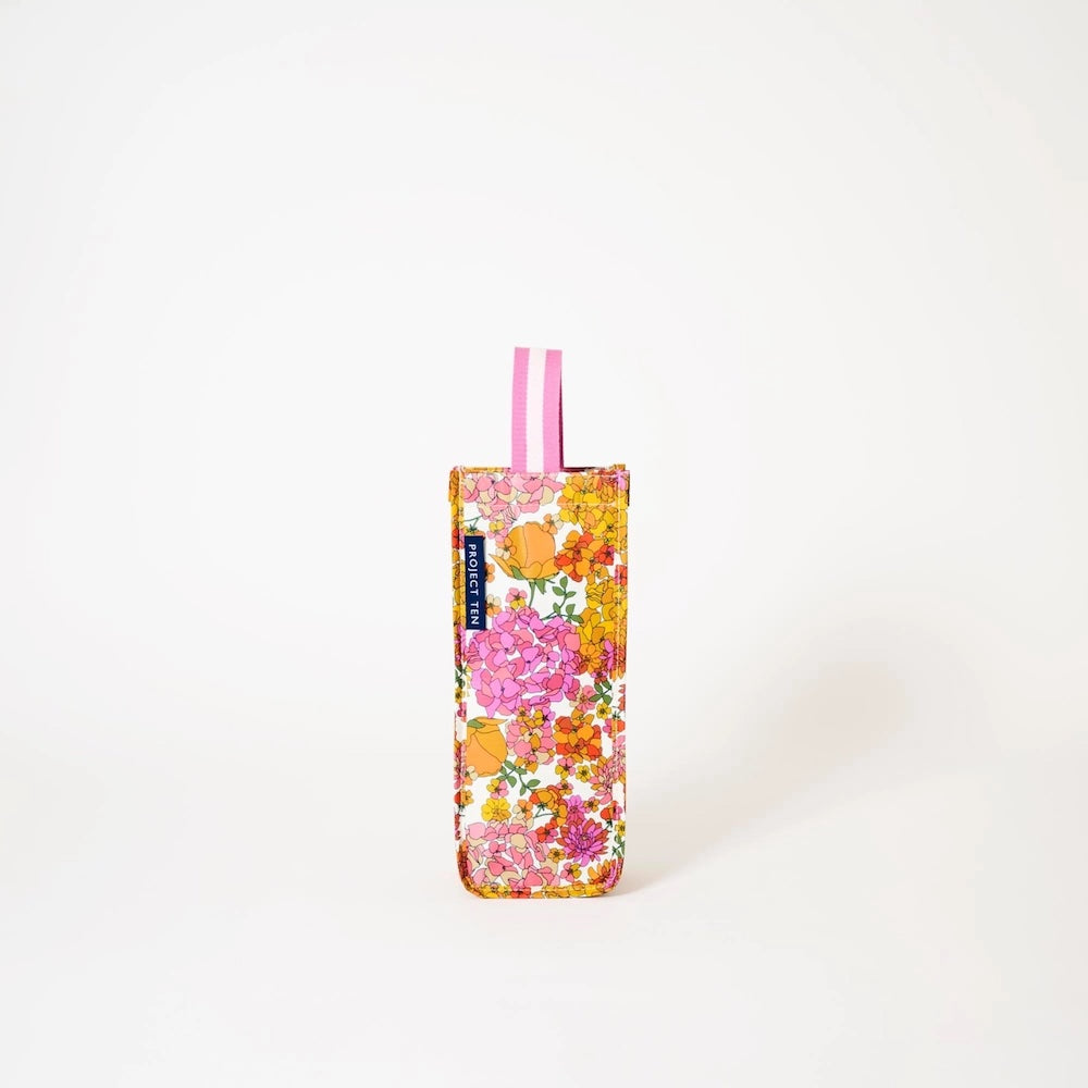 Floral-patterned wine bag with pink and white straps on a white background