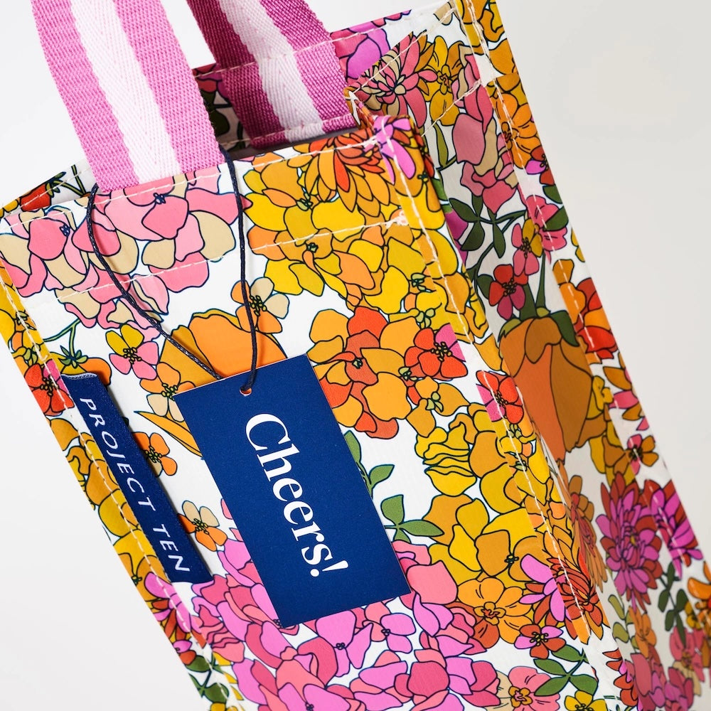 Floral-patterned wine bag with a 'Cheers!' tag and 'Project Ten' label on a white background