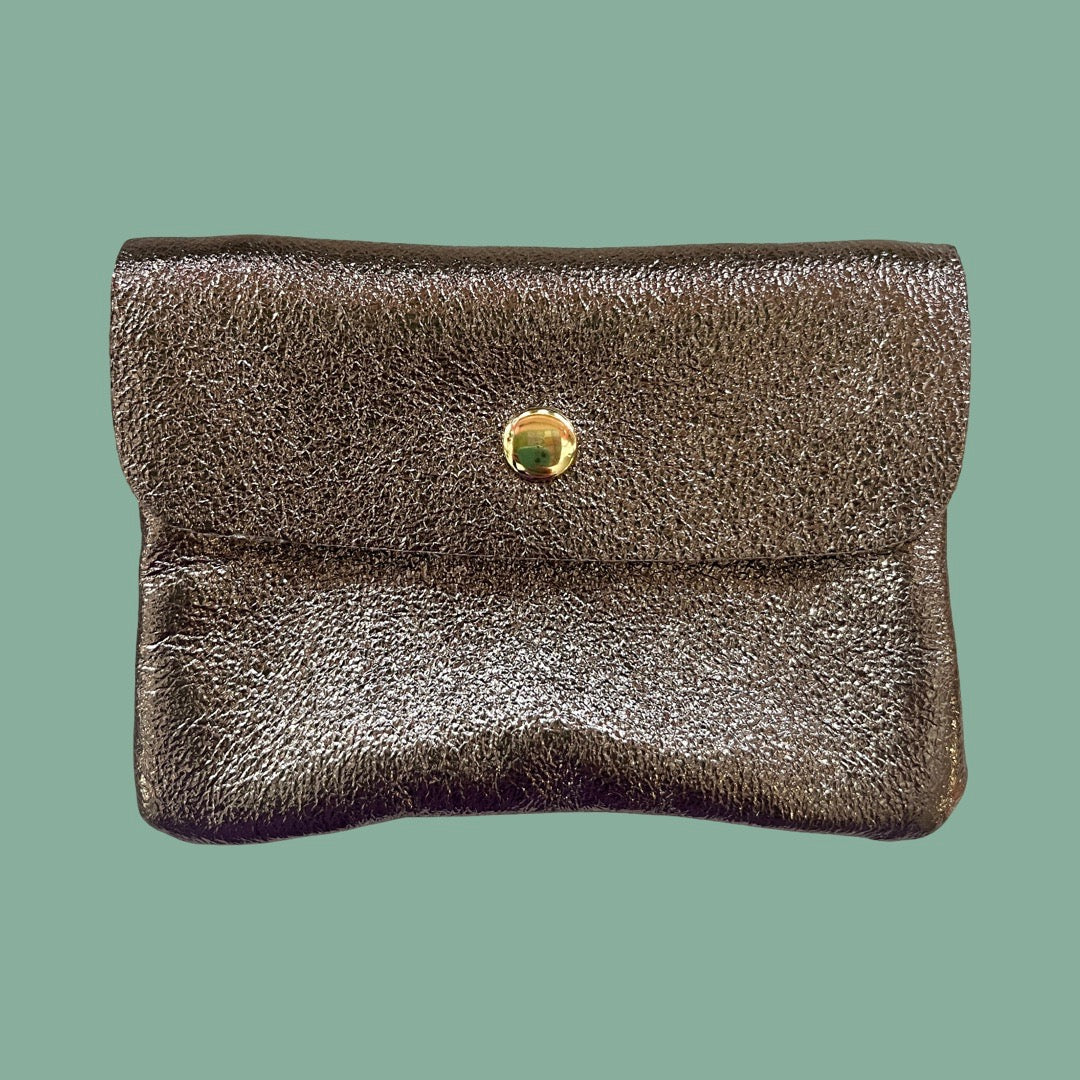 A small brown textured leather pouch with a flap closure and a gold-tone button, shown against a solid sage green background.