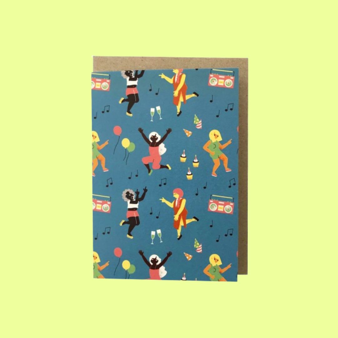 A greeting card with a brown envelope, featuring a blue background printed with colourful illustrations of dancing people, boomboxes, balloons, champagne glasses, and musical notes, shown against a pale yellow-green background.