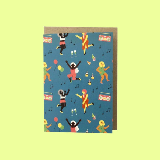 A greeting card with a brown envelope, featuring a blue background printed with colourful illustrations of dancing people, boomboxes, balloons, champagne glasses, and musical notes, shown against a pale yellow-green background.