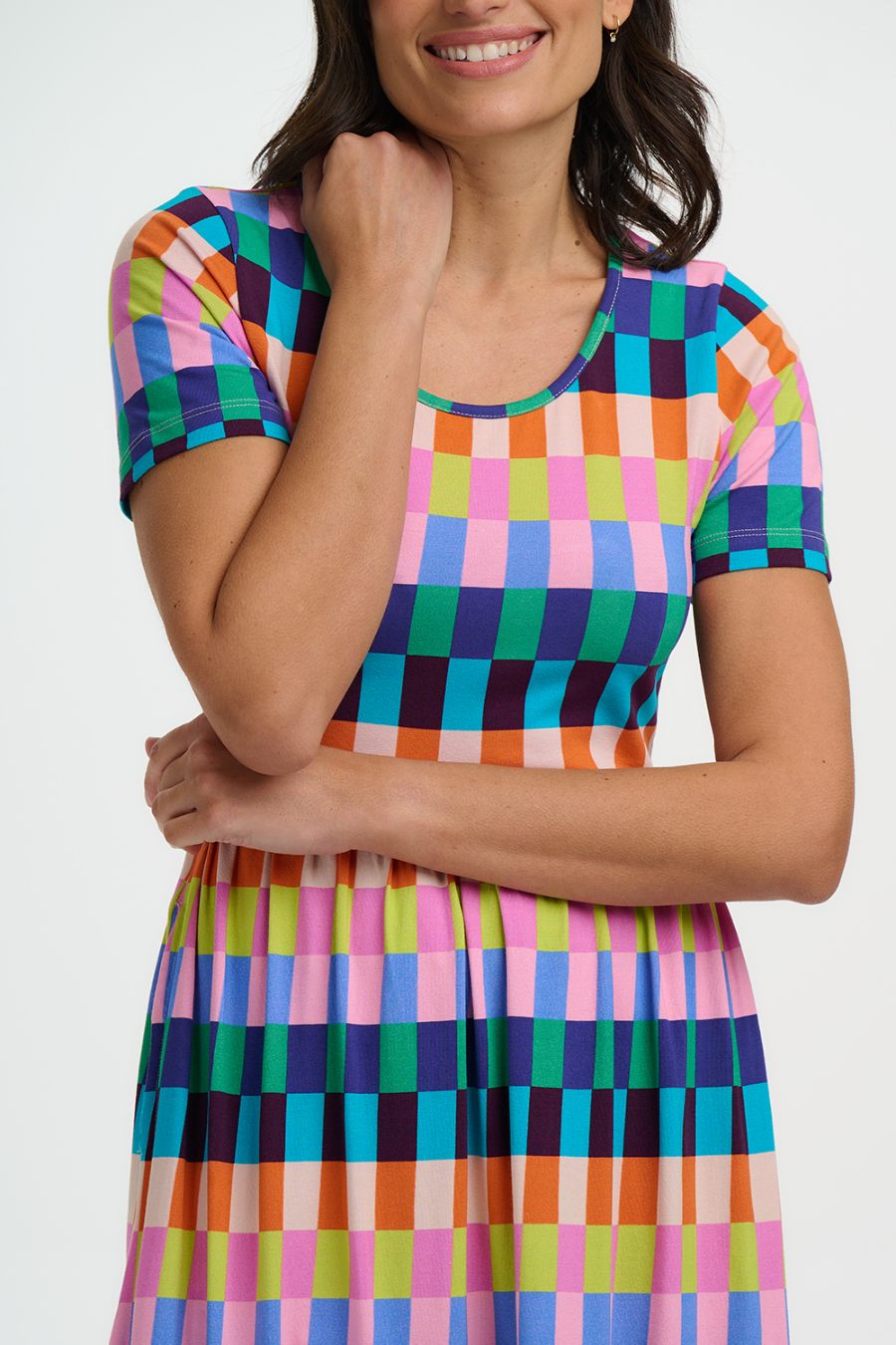 Close up of Woman wearing a colorful checkered dress on a white background