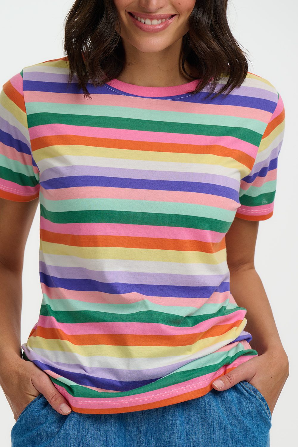 Person wearing a colorful striped shirt with a plain background