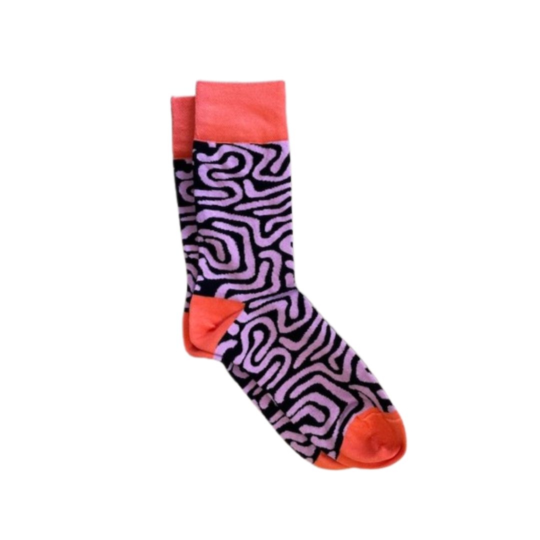 A pair of Afropop socks with a purple and navy pattern and orange accents on a white background