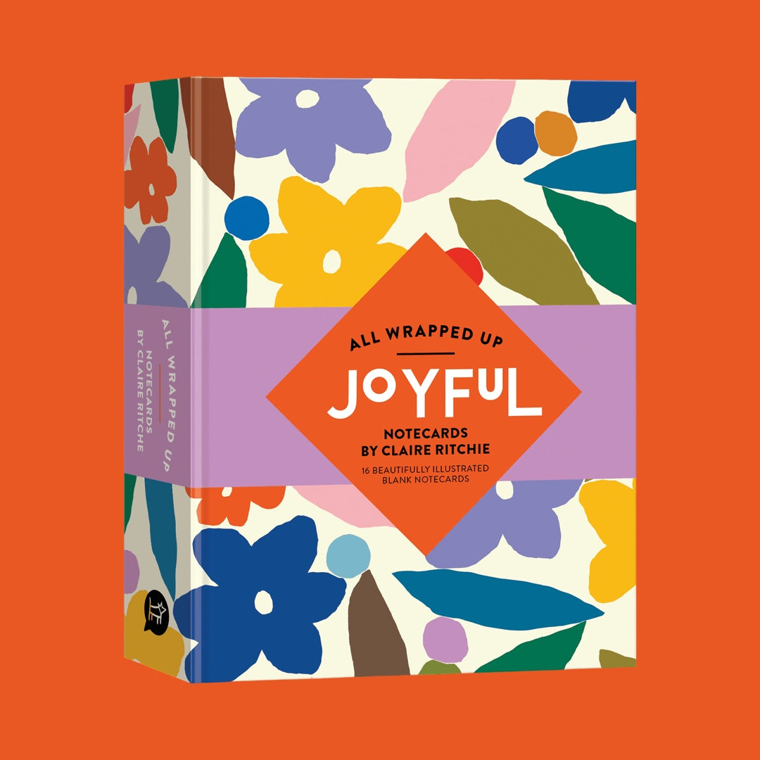 All Wrapped Up: Joyful notecards box by Claire Ritchie against a solid orange background. The packaging features a colourful retro-inspired floral pattern.