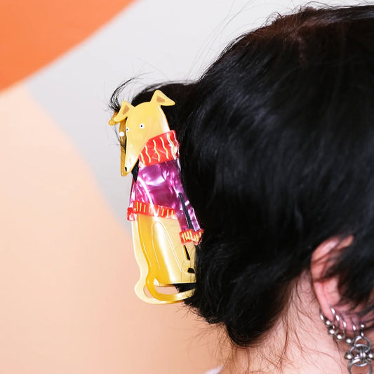 A hair claw shaped like a Greyhound wearing a knitted jumper in black hair.