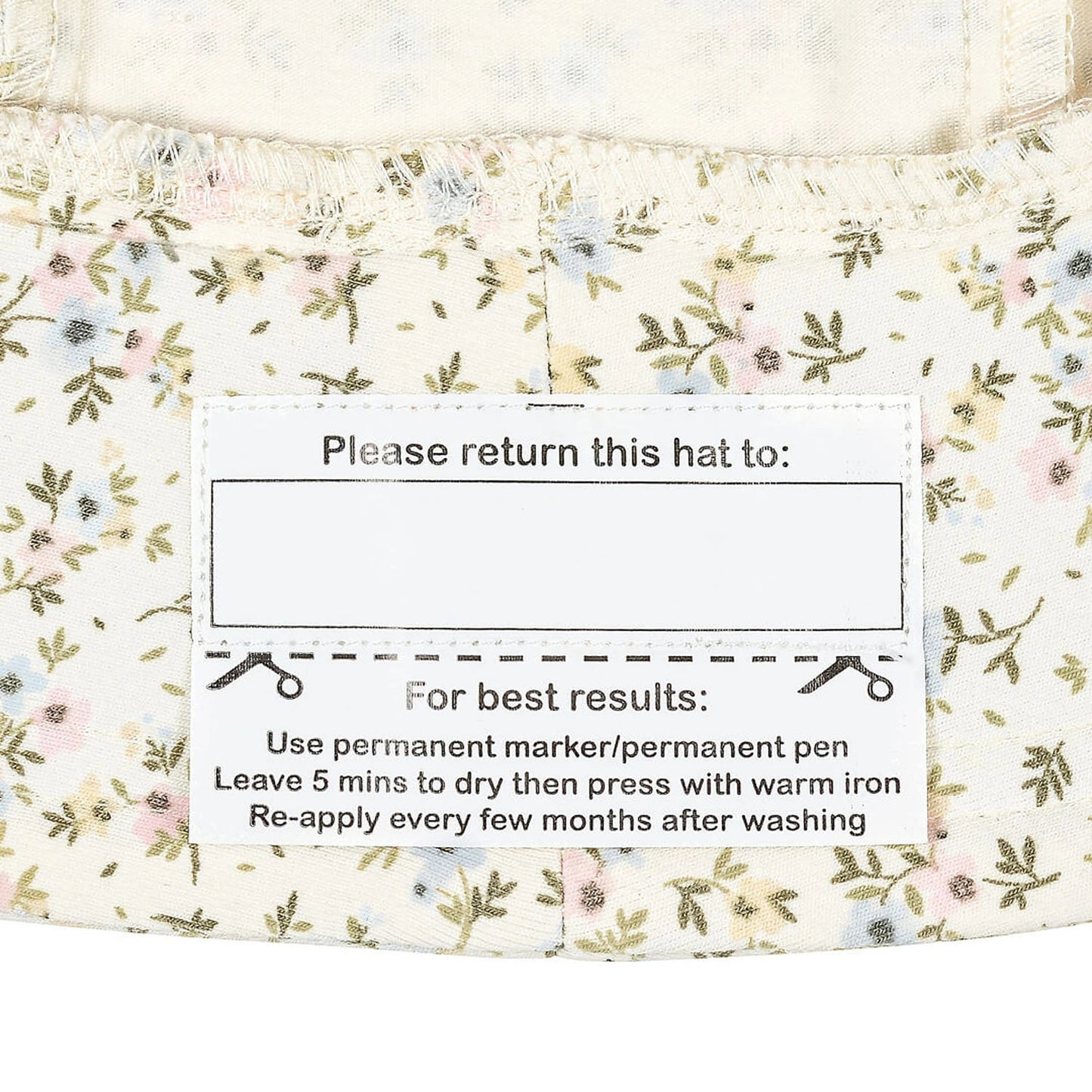Floral-patterned fabric with care label instructions on a white background