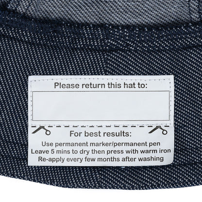 Label on a denim hat with care instructions.