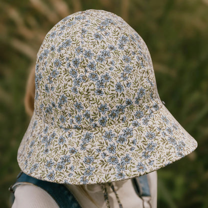 Top view of Floral patterned bucket hat worn by a child with a blurred natural background