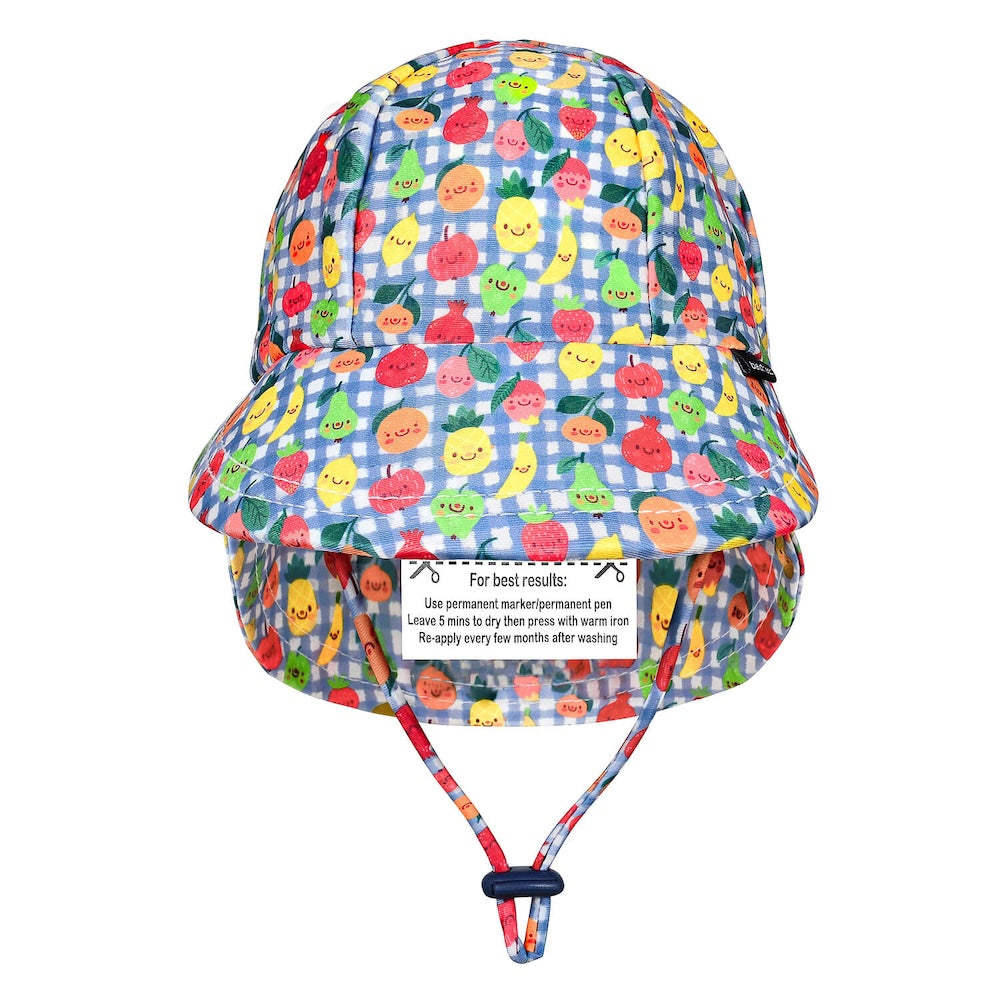 A children's bucket hat with a blue and white gingham pattern and a colourful print of smiling cartoon fruits, including pineapples, strawberries and oranges. It features an adjustable chin strap with a dark blue toggle.