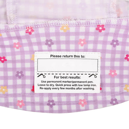 Close-up of the name label inside the brim of a lavender and white gingham swim hat with small pink, purple and yellow floral print.
