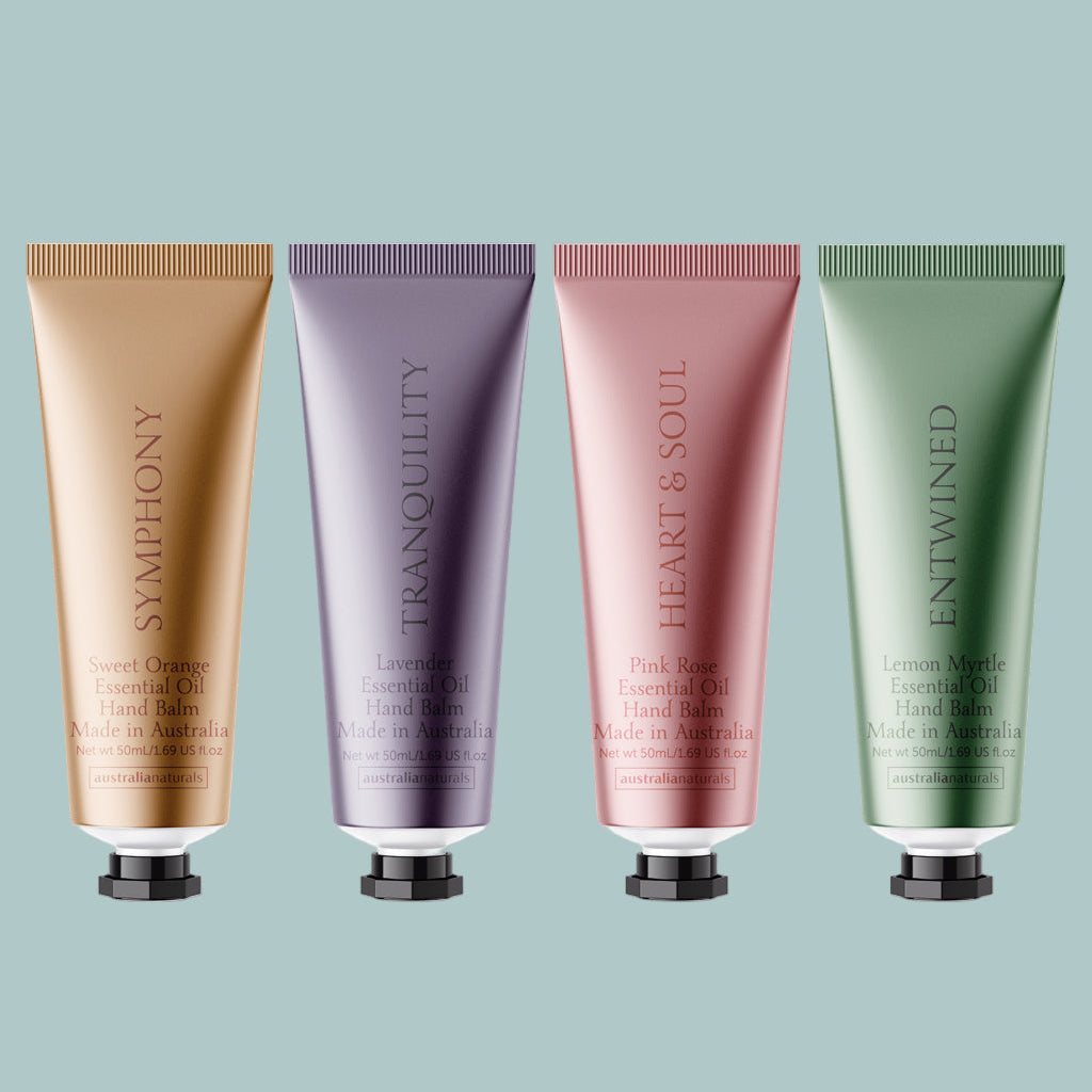 Four hand cream tubes with different colors and branding on a white background