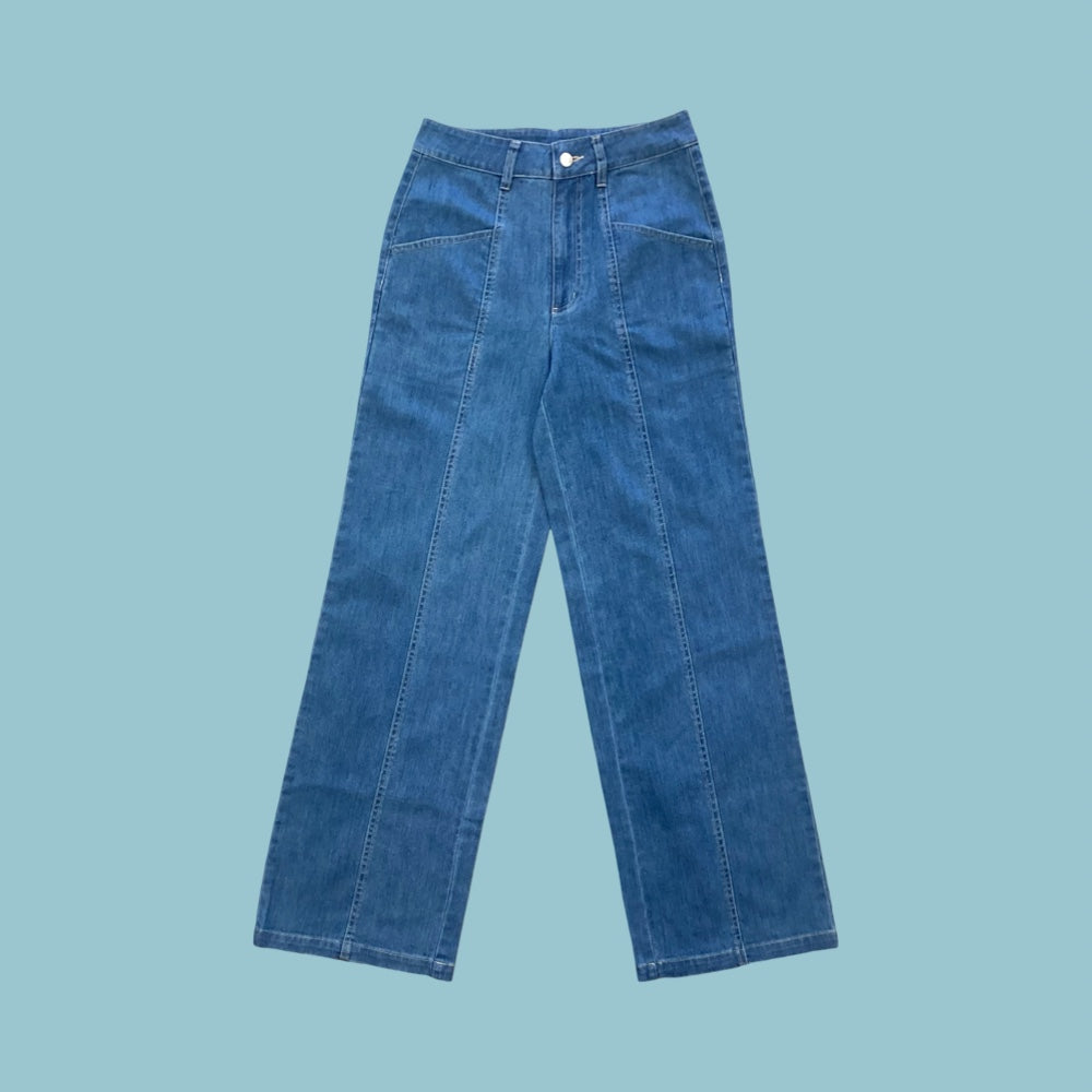 Frock Me Out denim jeans in a vintage blue wash on a pale blue background