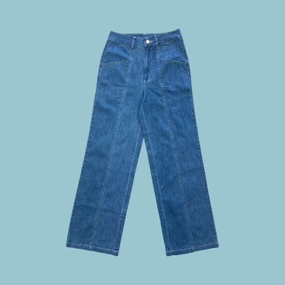 Frock Me Out denim jeans in a vintage blue wash on a pale blue background
