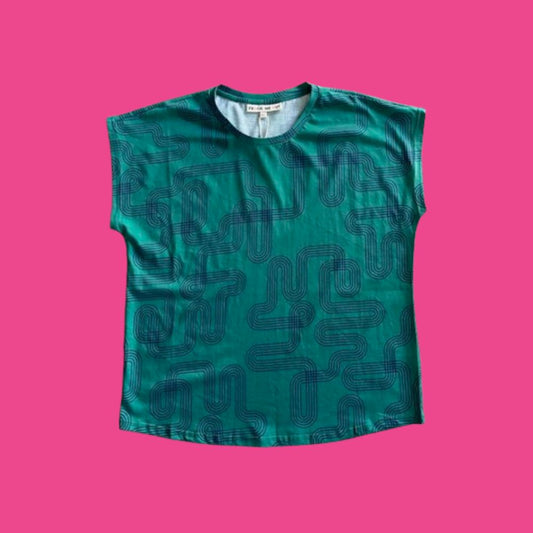 Frock Me Out Labyrinth Capped Sleeve Tee - Green sleeveless shirt with navy blue geometric pattern on a pink background