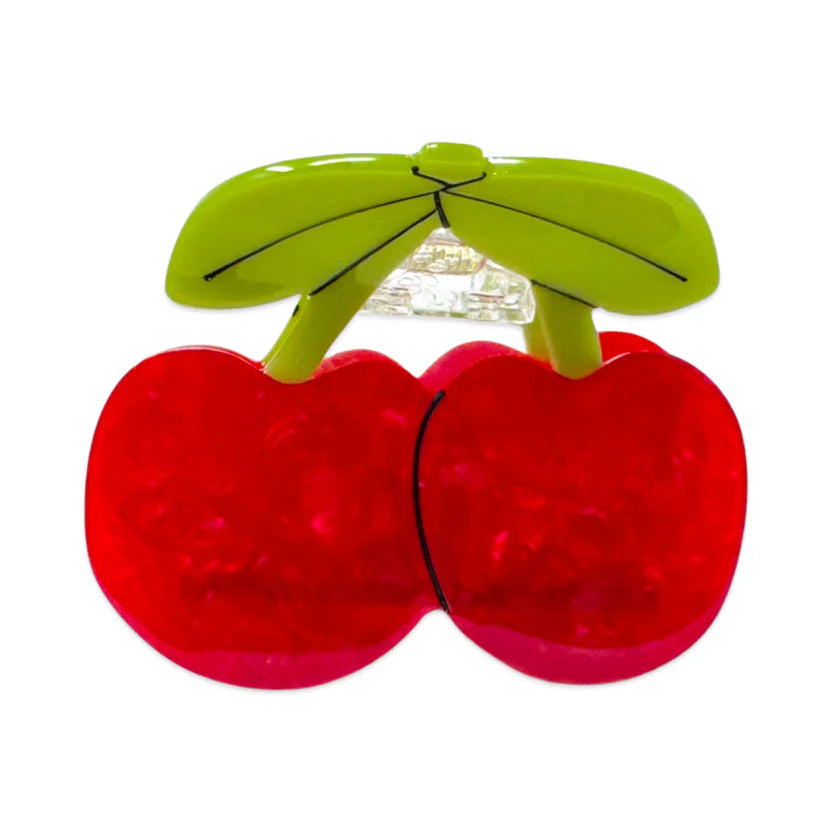 Red bio-cellulose cherries hair claw with green leaves on a white background