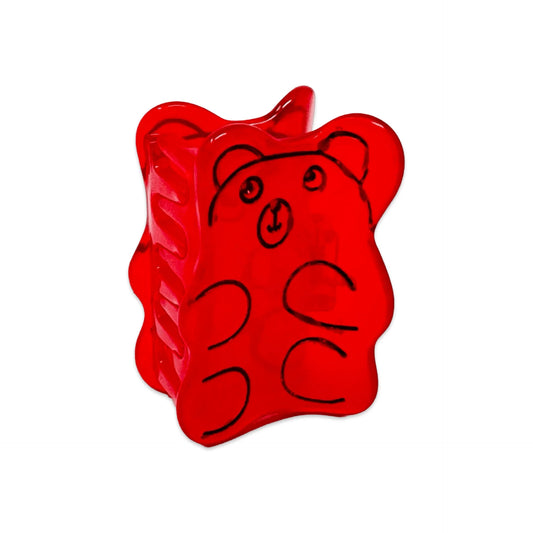 Red gummy bear hair clip with black outlines on a white background