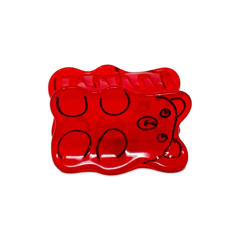 Red gummy bear hair clip with black outlines on a white background