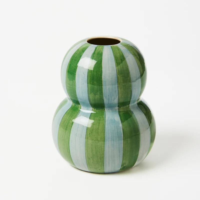 Green and white striped ceramic vase on a white background