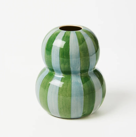 Green and white striped ceramic vase on a white background