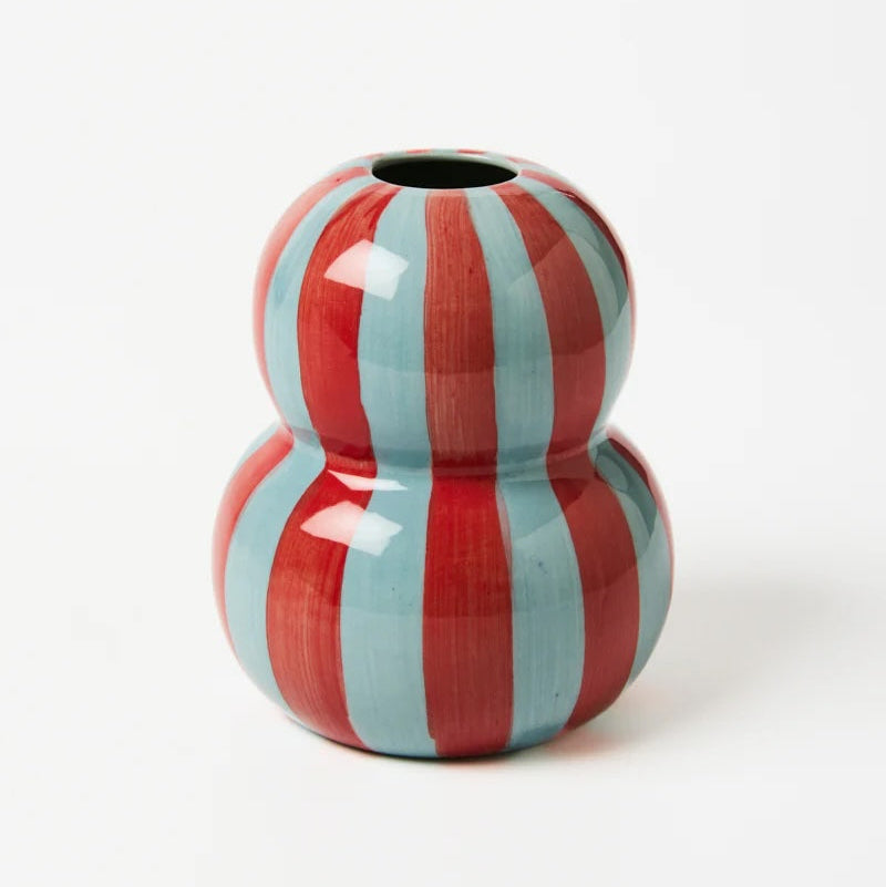 Two-toned red and light blue striped ceramic vase on a white background