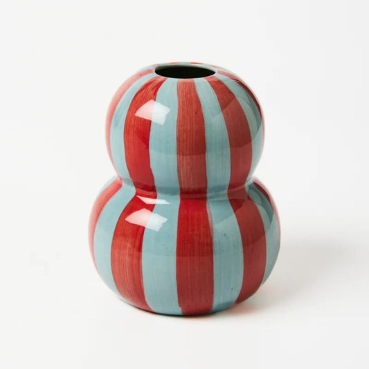 Two-toned red and light blue striped ceramic vase on a white background
