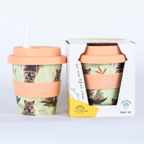 Two Little Cino Social Quokka Babycino Cups side by side. The left one has a white coloured straw inserted through the mouthpiece, and the one on the right is in its paper packaging box.