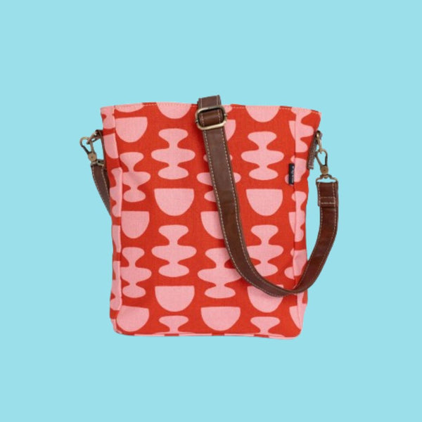 Maika City Sling Bag in Nacka. Pink coloured bubbly patterns with a red coloured background.