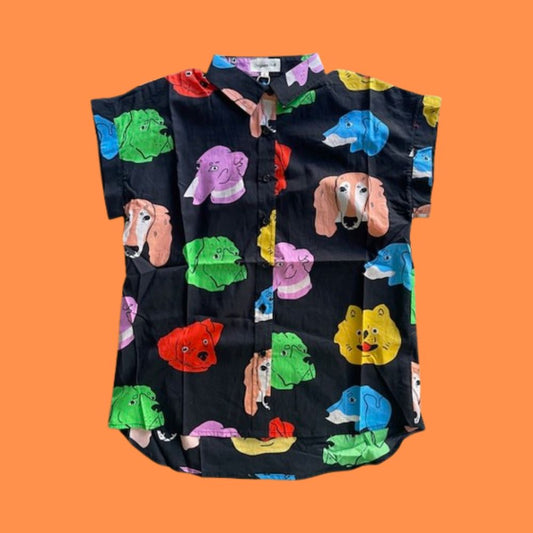 Black shirt with colorful dog pattern on an orange background