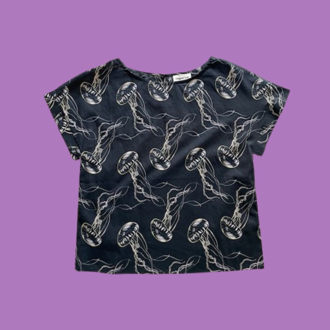 Black t-shirt with jellyfish pattern on a purple background